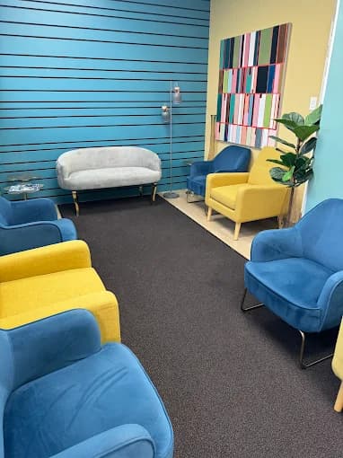 A freshly cleaned lounge with blue and yellow chairs